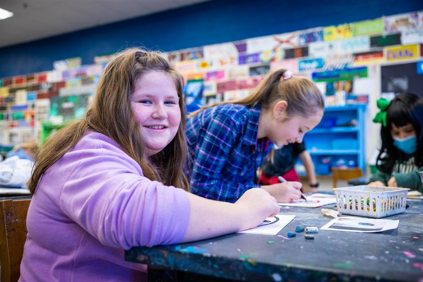 Students in an art class using oil pastels
